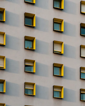 yellow painted building's window frame