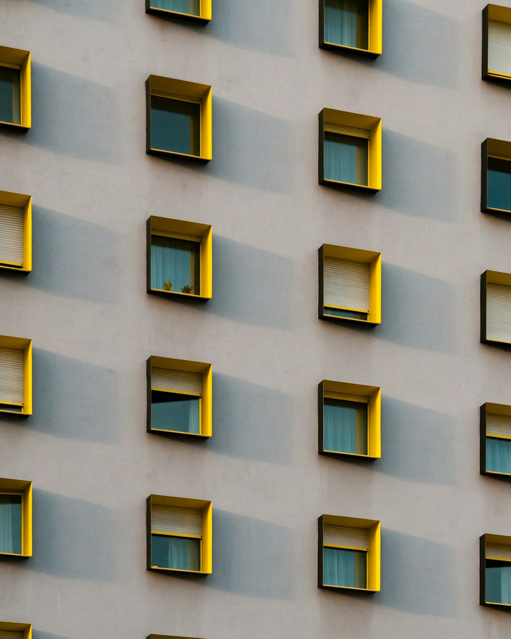 yellow painted building's window frame