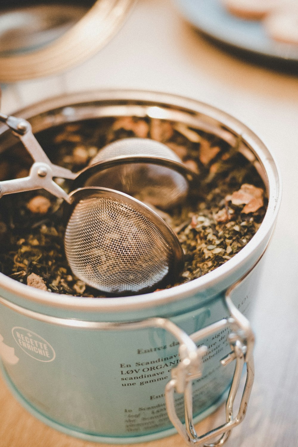 silver strainer on blue jar