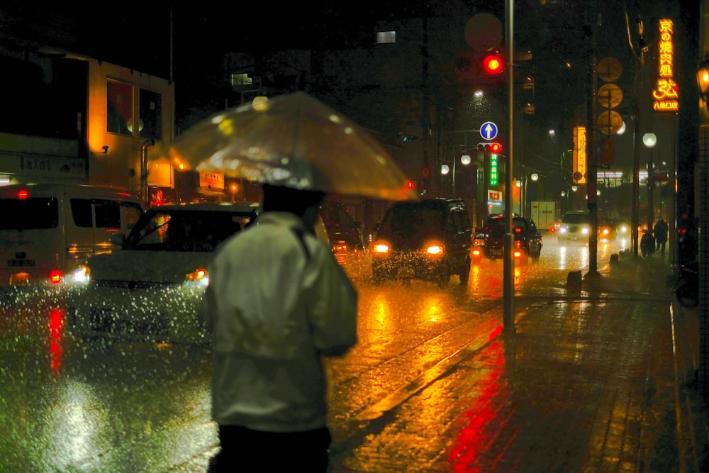 man using clear silicon umbrella during raining