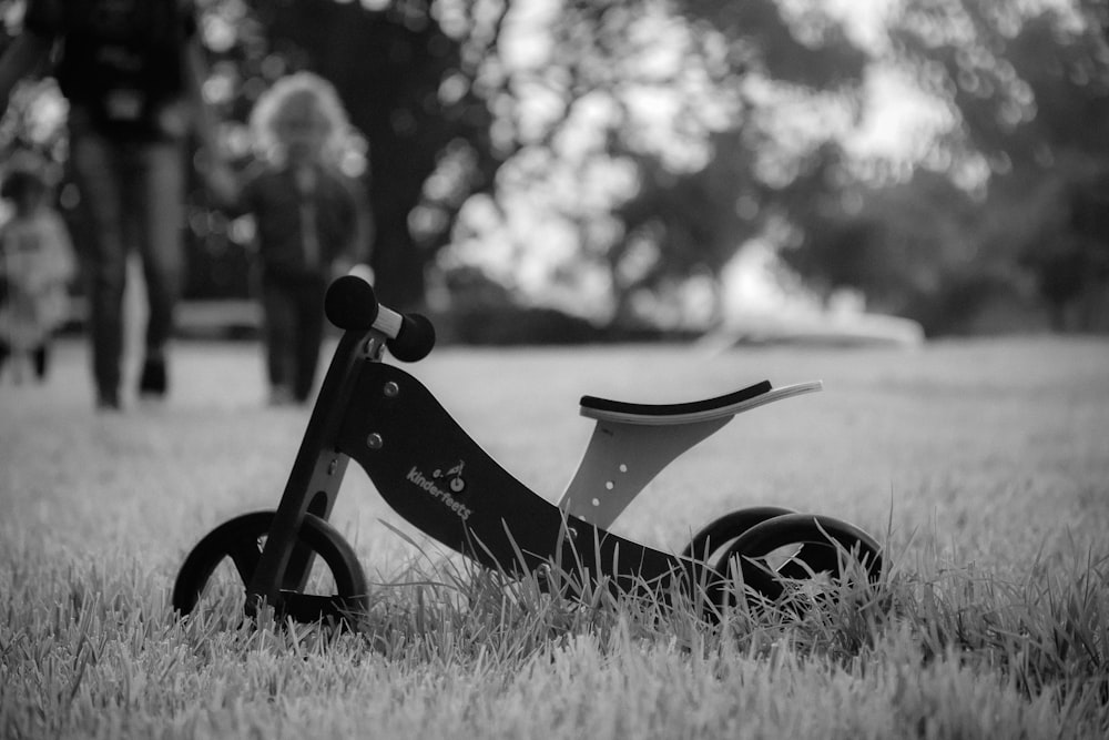 grayscale photography of bicycle on grass