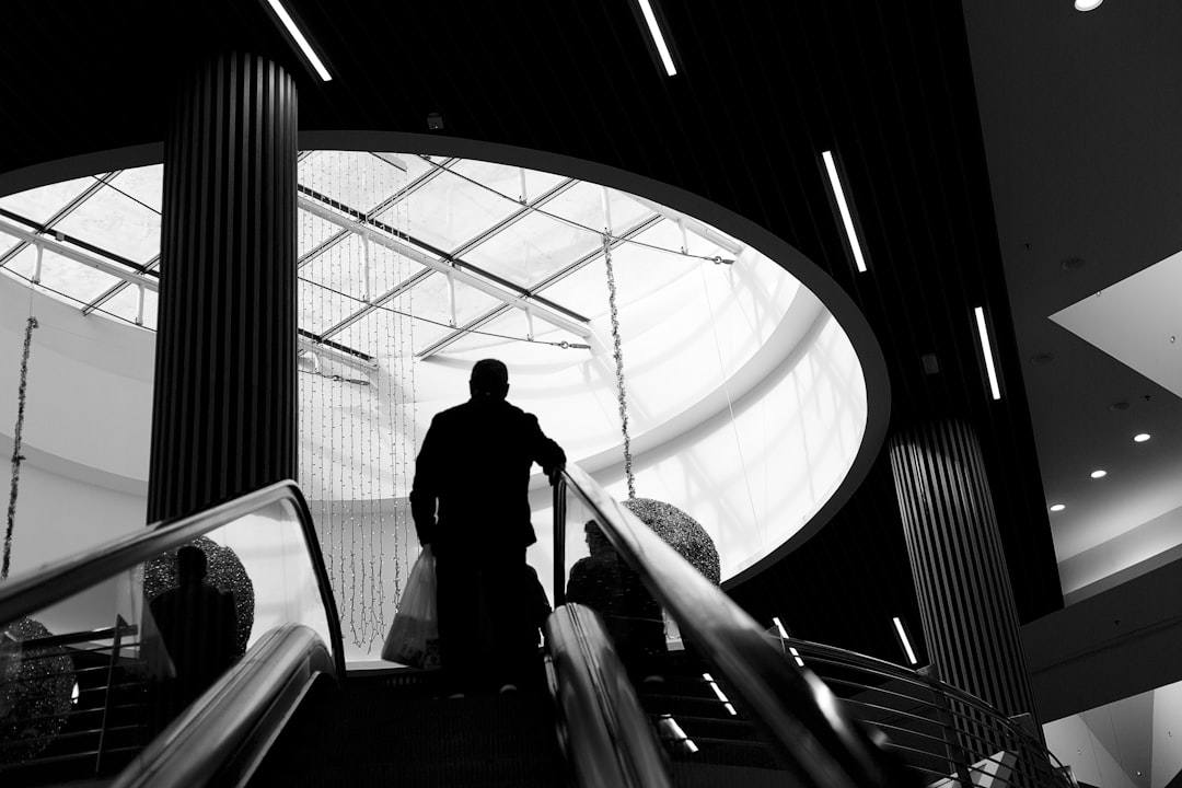 grayscale photography of man on stairs