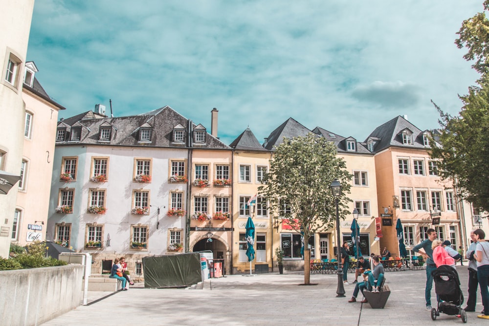 people gathered by buildings during daytime