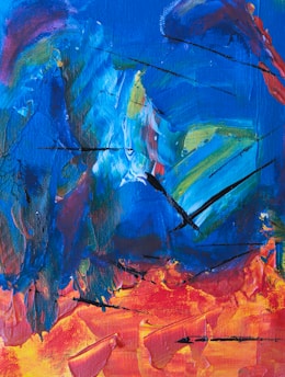 An abstract painting featuring swirling blue tones mixed with splashes of vibrant red, orange, and yellow. The composition includes bold black lines that cut through the colors, creating a sense of movement and energy.
