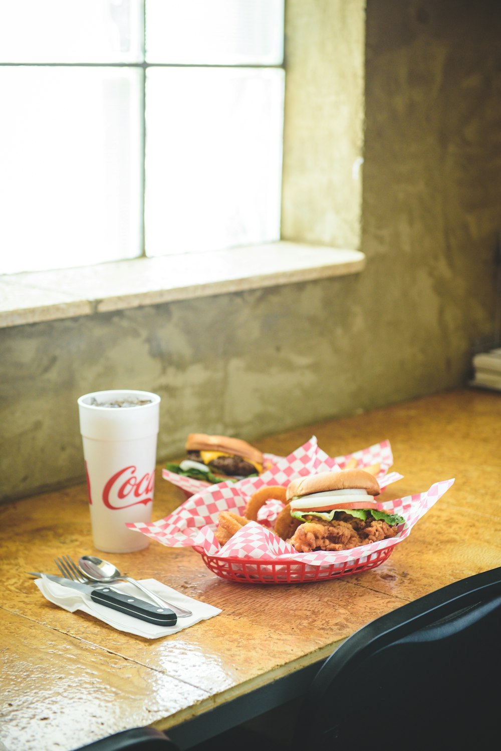 hamburger and food in basket by window