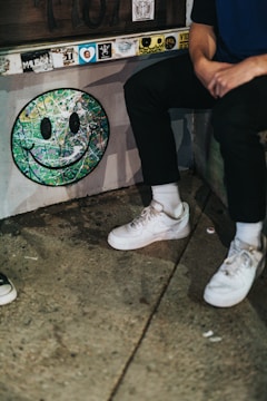 Smiling artists sharing their artwork on a vibrant digital platform.