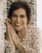 woman in white and orange floral shirt smiling