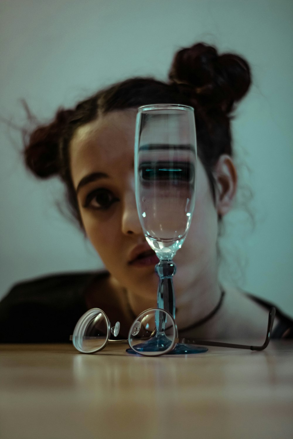 clear glass wine glass on top of table overlooking woman