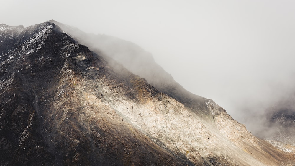 mountain covered with white smoke during daytime