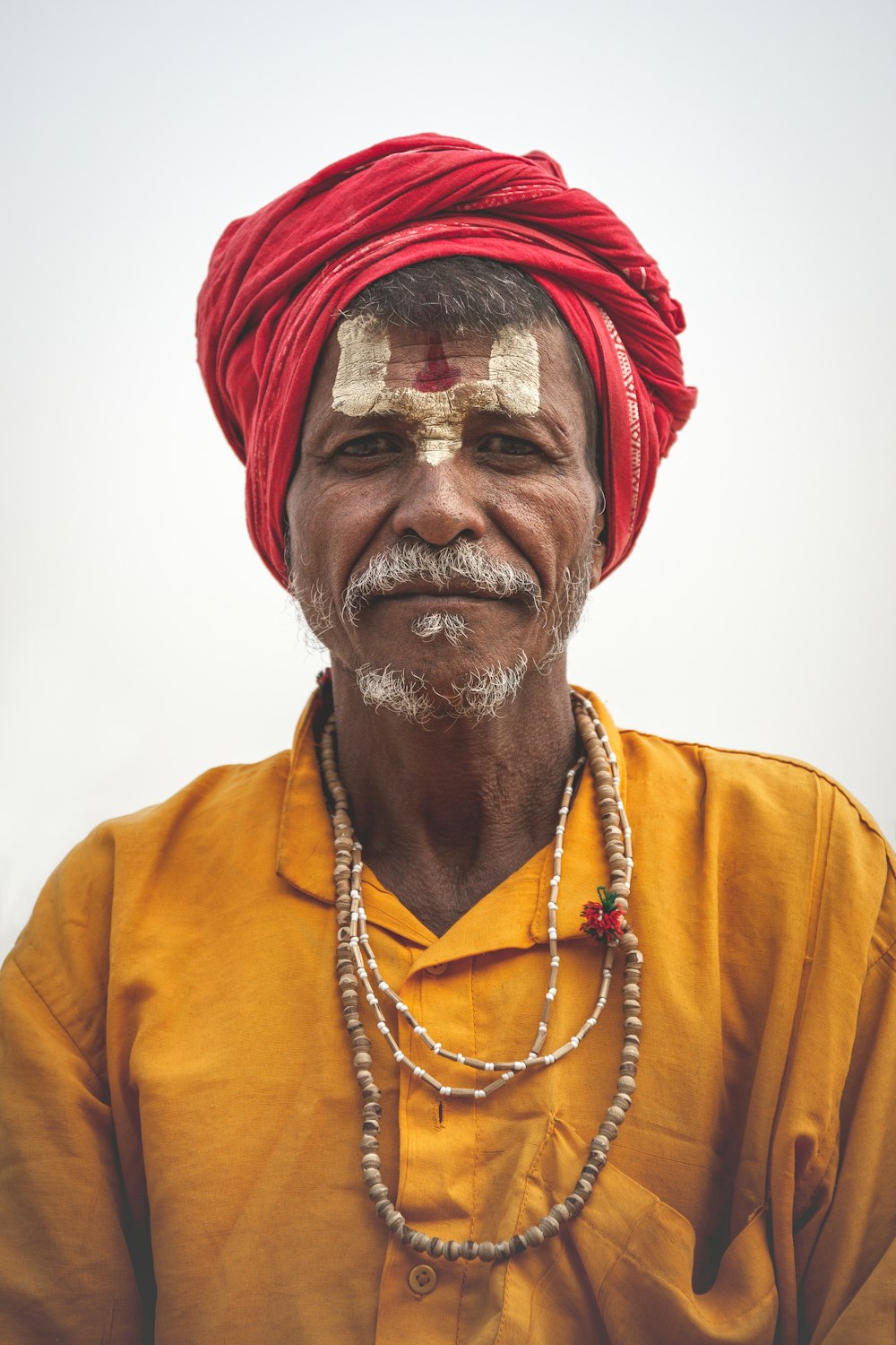 man wearing red headdress