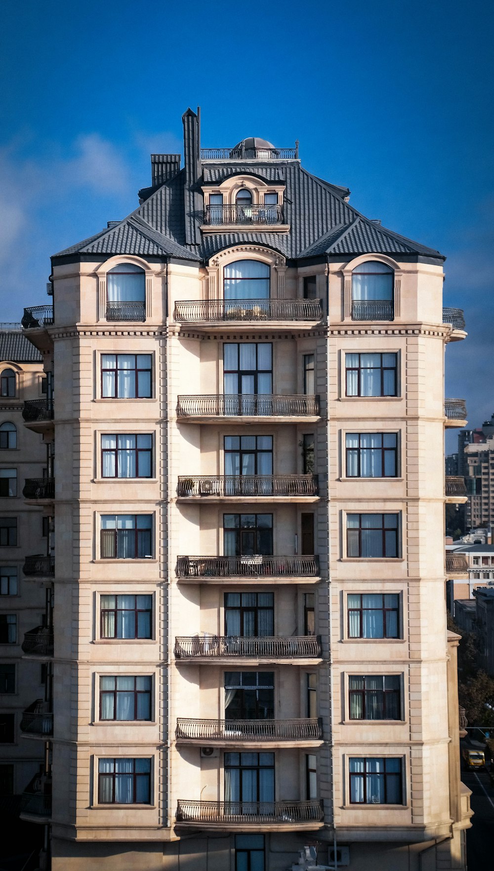 white and gray concrete building with balconies during day