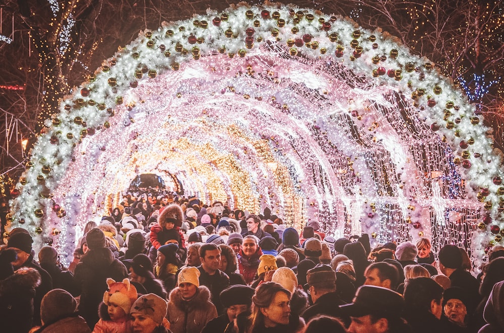 people inside lighted tunnel on nighttime