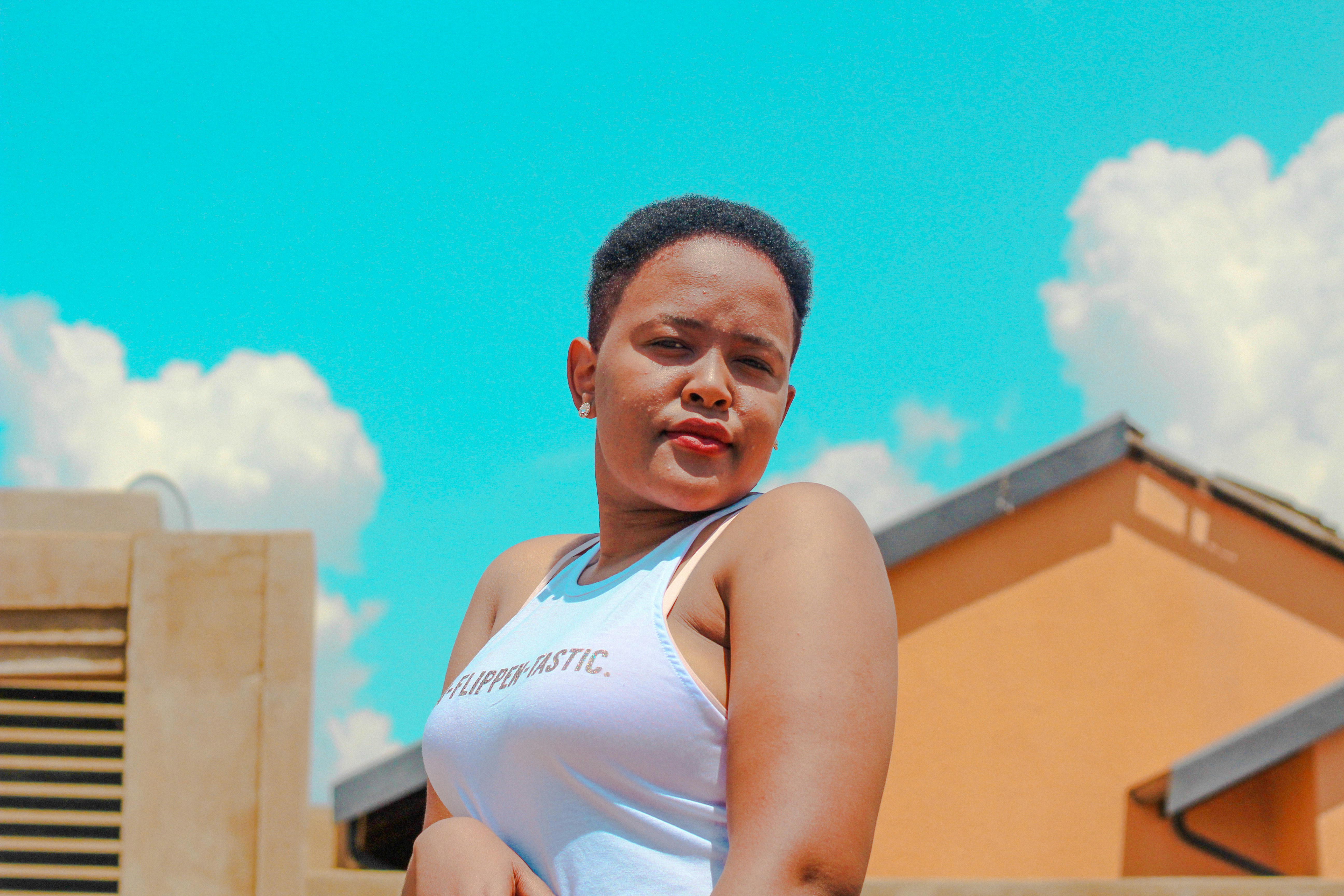 woman on front of beige house