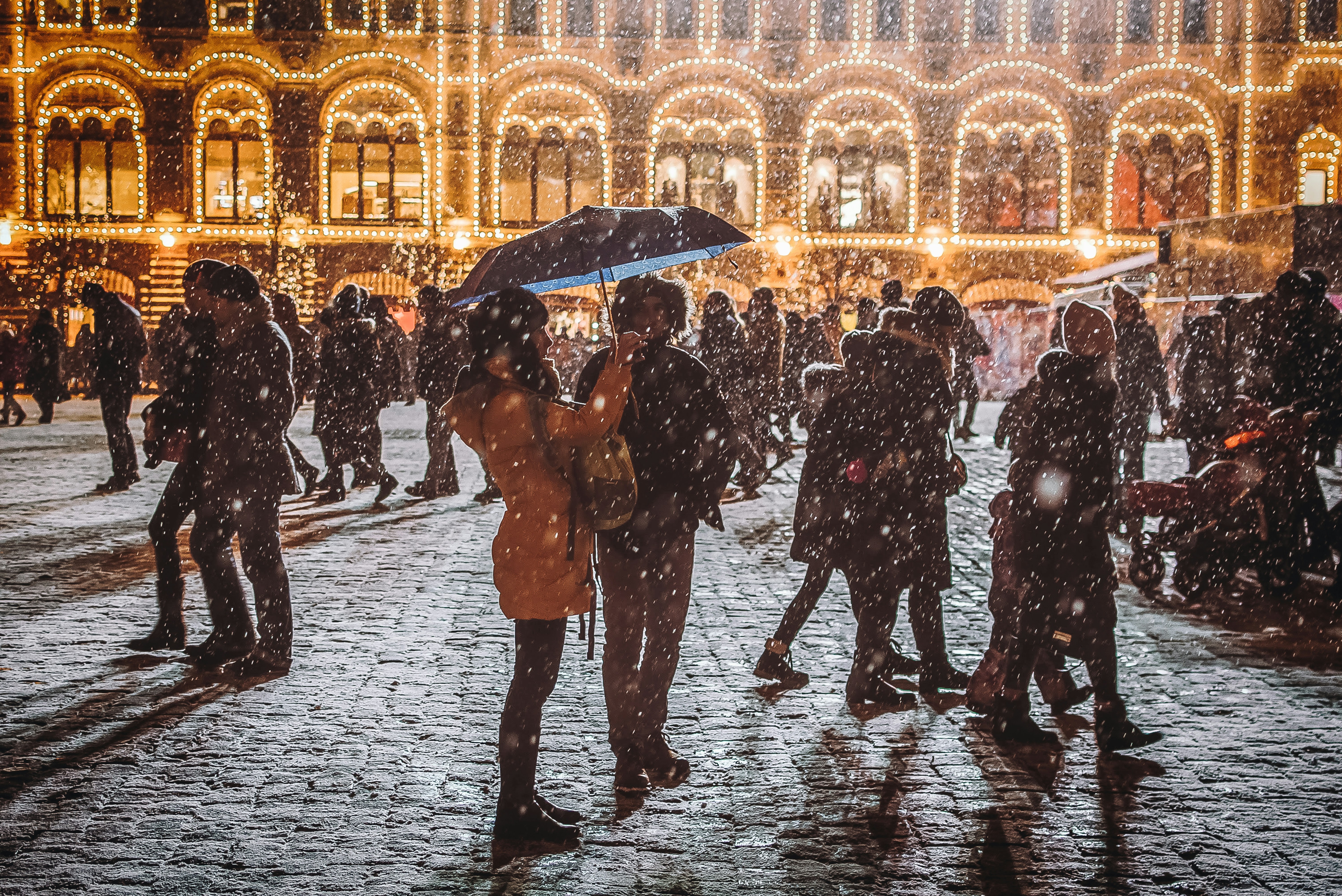 woman holding umbrella blizzard teams background