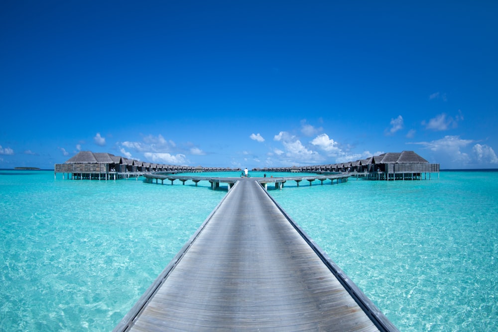 gray beach dock under blue skies