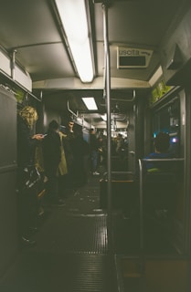 Happy travelers stepping into a premium shuttle with Rome cityscape in the background.