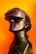 A sleek black mannequin head is adorned with a modern virtual reality headset, against a vibrant orange background. The VR headset is slightly futuristic in design, with smooth curves and a matte finish. A coiled black wire wraps around the neck of the mannequin, adding a sense of technological sophistication.