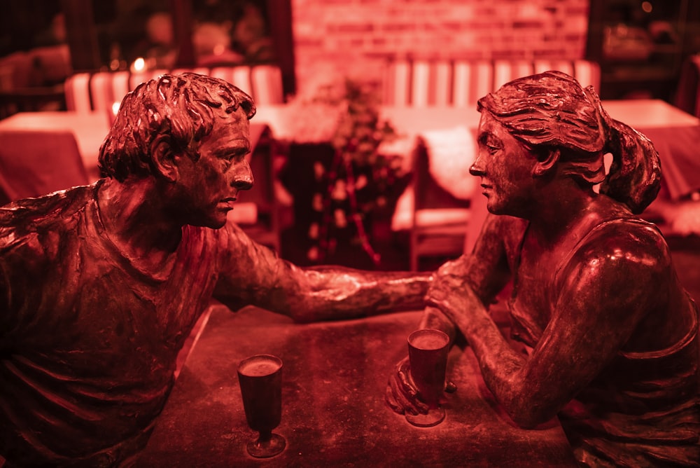 man touching woman's face statue