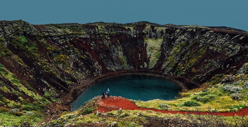 body of water between mountain during daytime