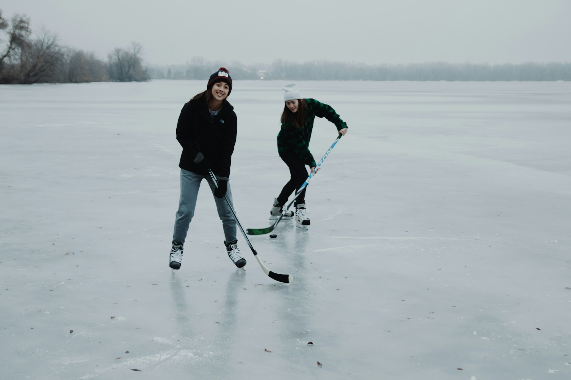 two women playing ice hockey