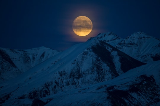 snow coated mountain at night time in Alaska United States