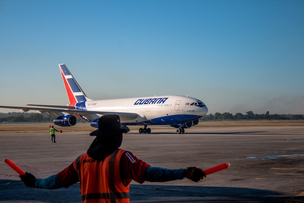 white and blue airliner on gray ground during daytime