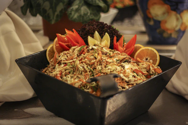 A colorful salad bowl served alongside an air fryer vegetable dish.