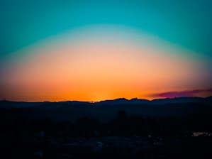 A breathtaking landscape photograph showcasing vibrant colors of a sunset over mountains.
