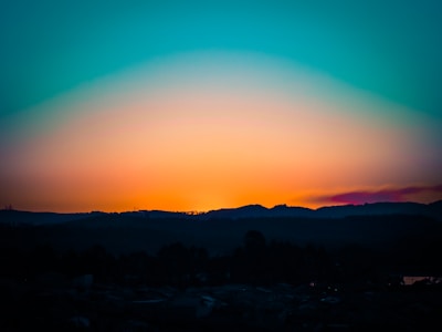 A breathtaking landscape photograph showcasing vibrant colors of a sunset over mountains.