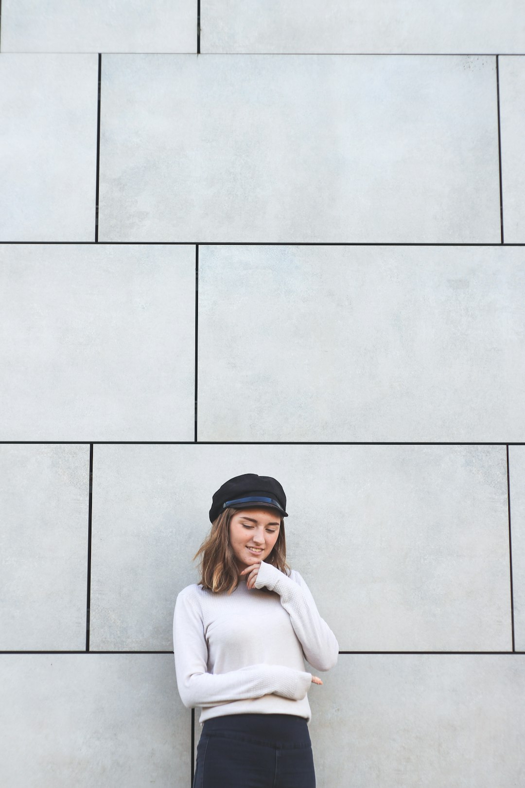 smiling woman leaning on wall