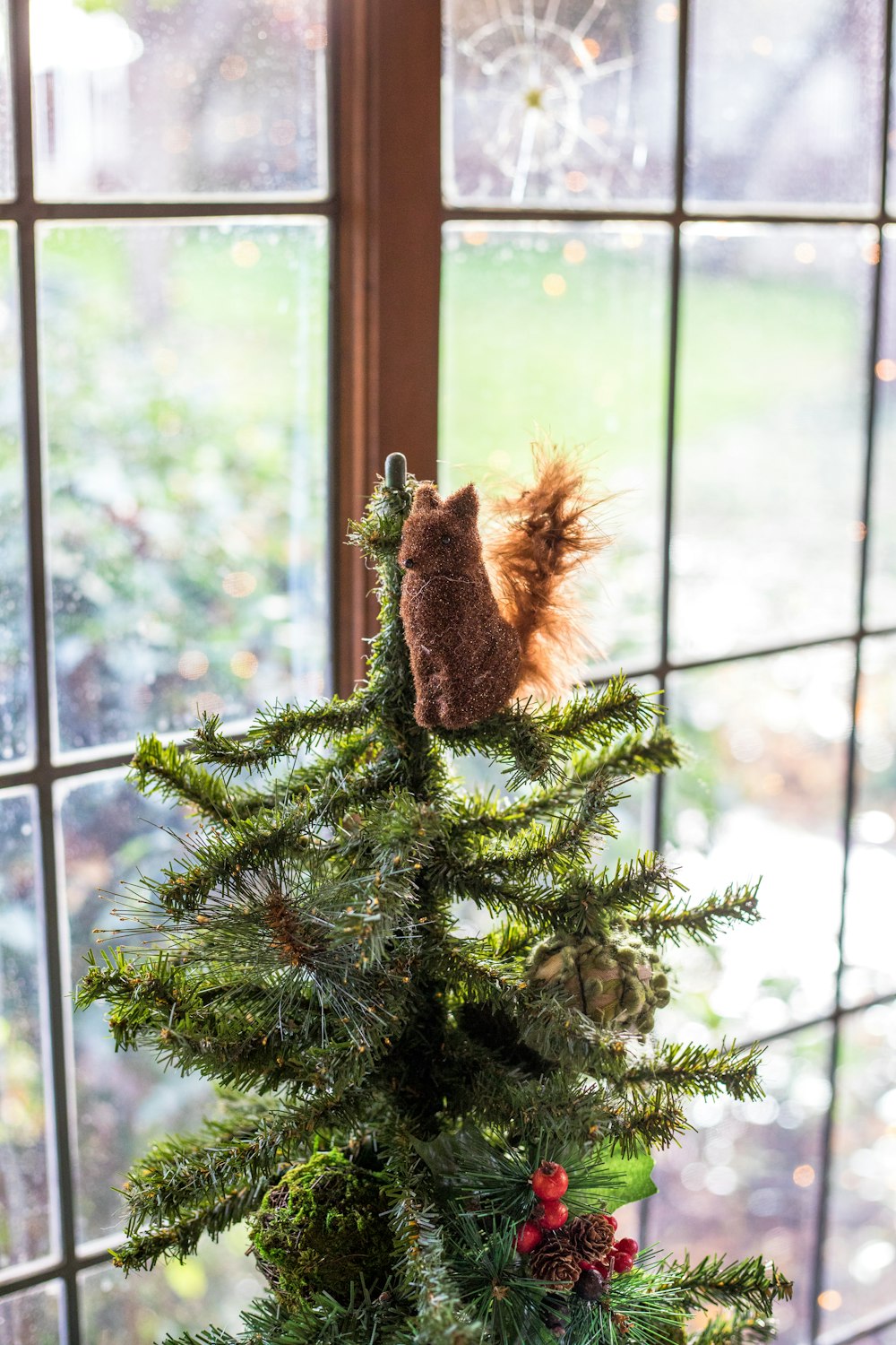 brown animal plush toy on green pine tree decoration