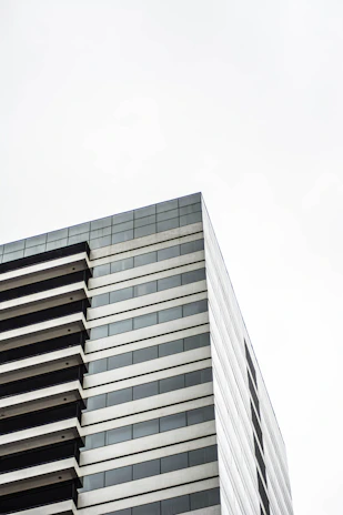 Contemporary office tower with sharp lines and a minimalist black and white color scheme.