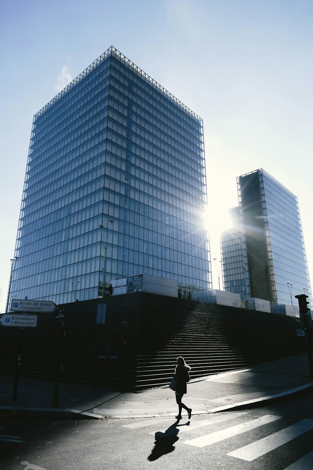 person walking near high-rise buildings