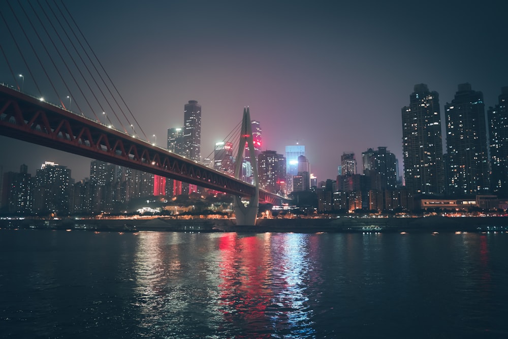 concrete bridge near city at night