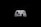 A white gaming controller with black buttons and joysticks is centered against a solid black background. The controller features various buttons, including the Xbox logo, directional pad, and colored action buttons labeled A, B, X, Y.