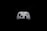 A white gaming controller with black buttons and joysticks is centered against a solid black background. The controller features various buttons, including the Xbox logo, directional pad, and colored action buttons labeled A, B, X, Y.