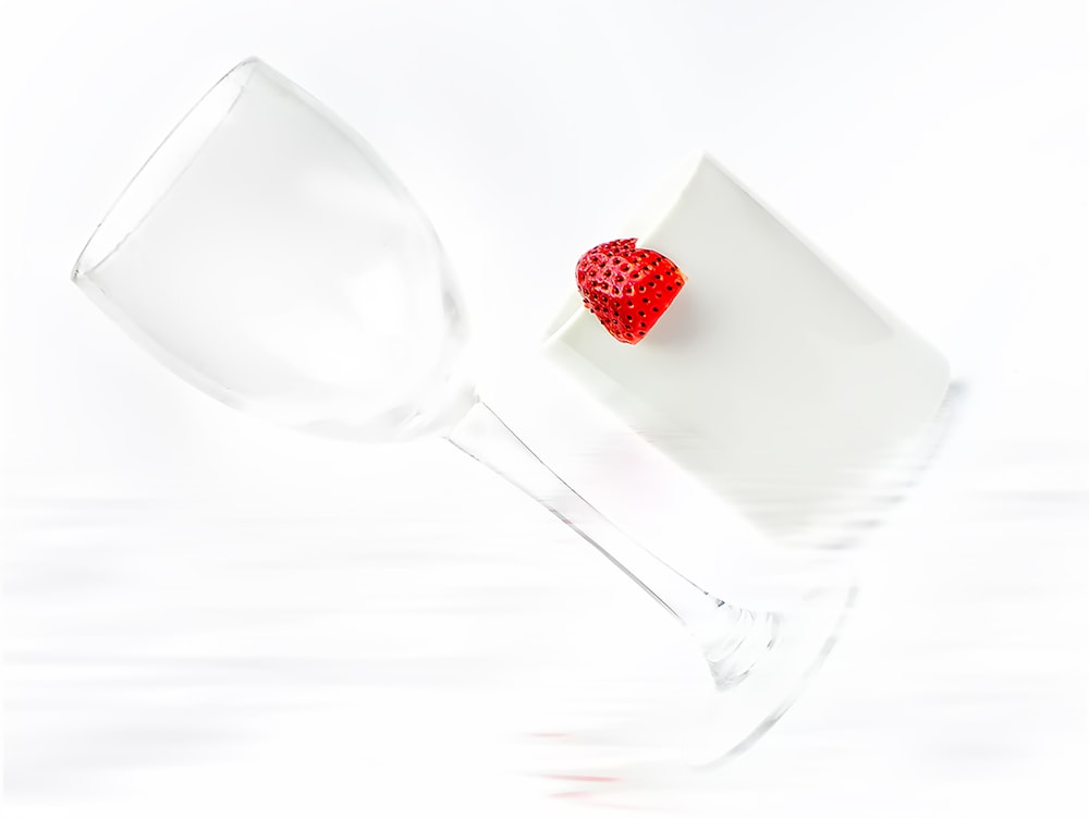 long-stem wine glass near strawberry fruit