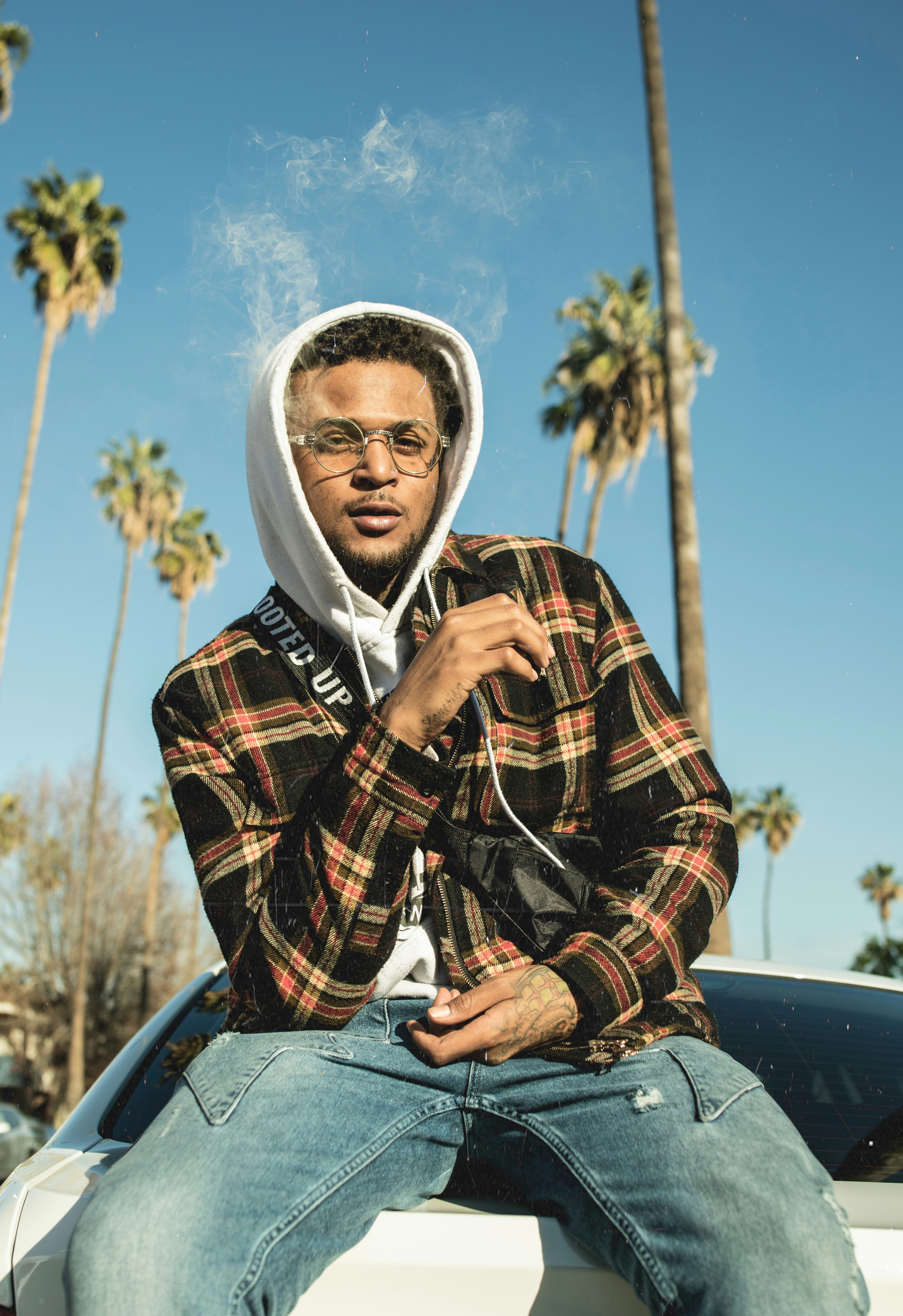 Man wearing black and brown plaid hoodie photo – Free Plant Image on  Unsplash