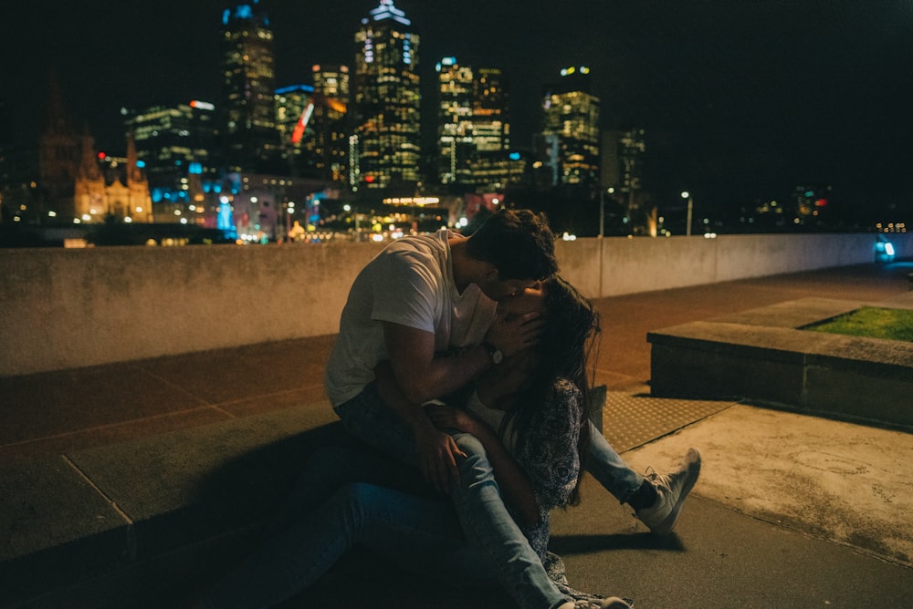 man and woman kissing during nighttime