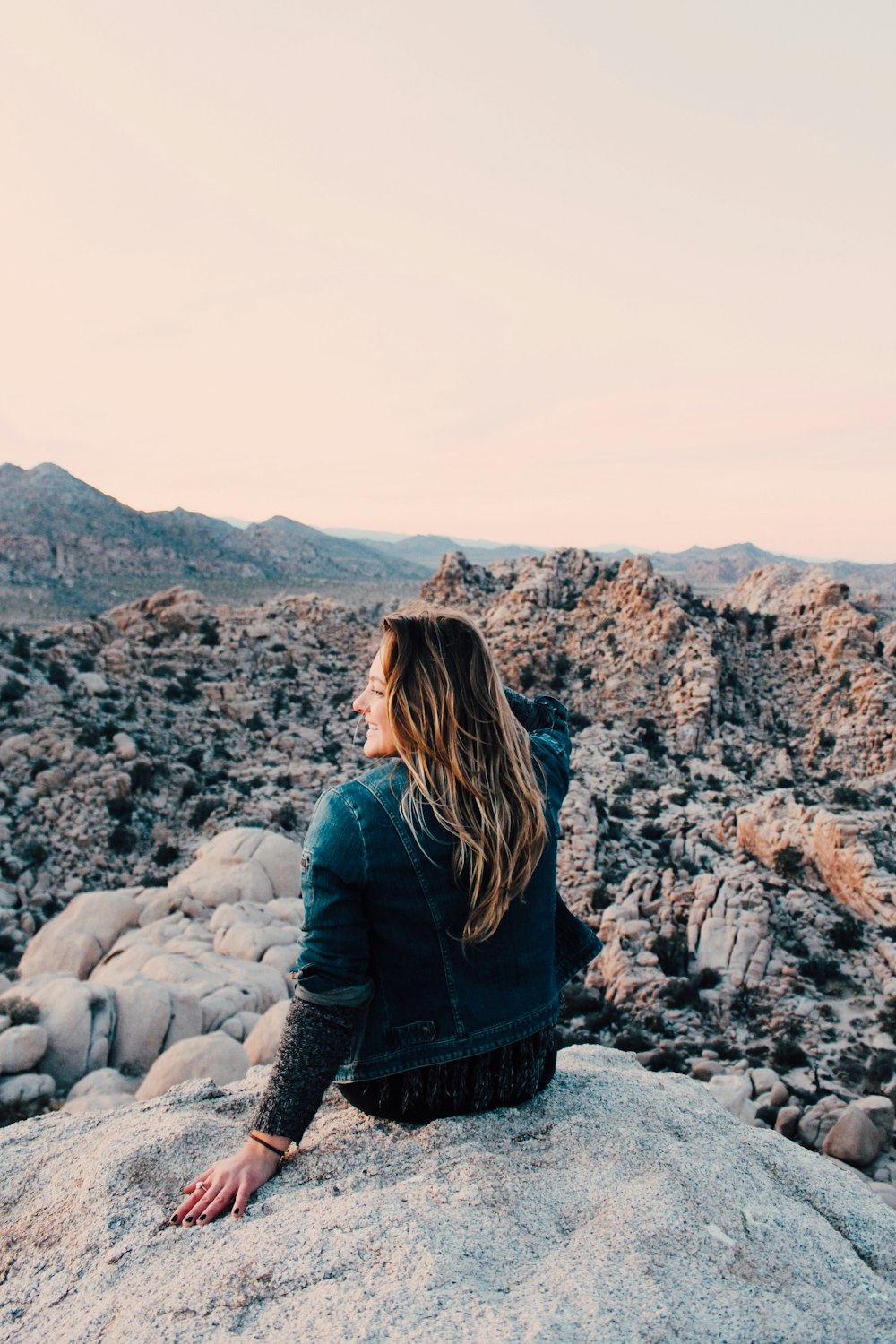 woman sitting on rock