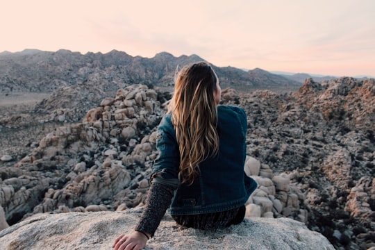 woman sitting on rock in Joshua Tree United States