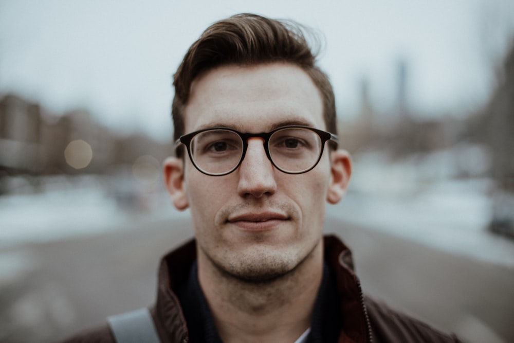 man wearing black framed sunglasses close-up photography