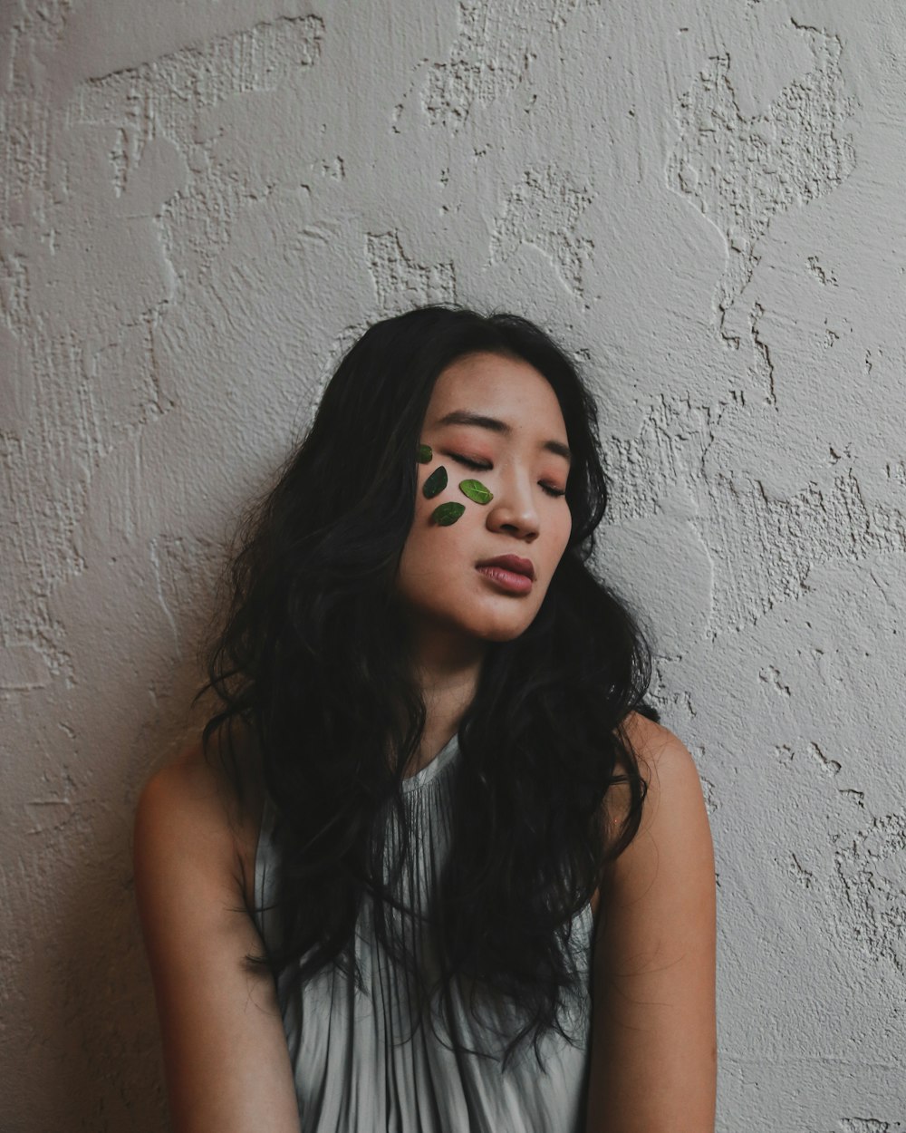 woman leaning on wall