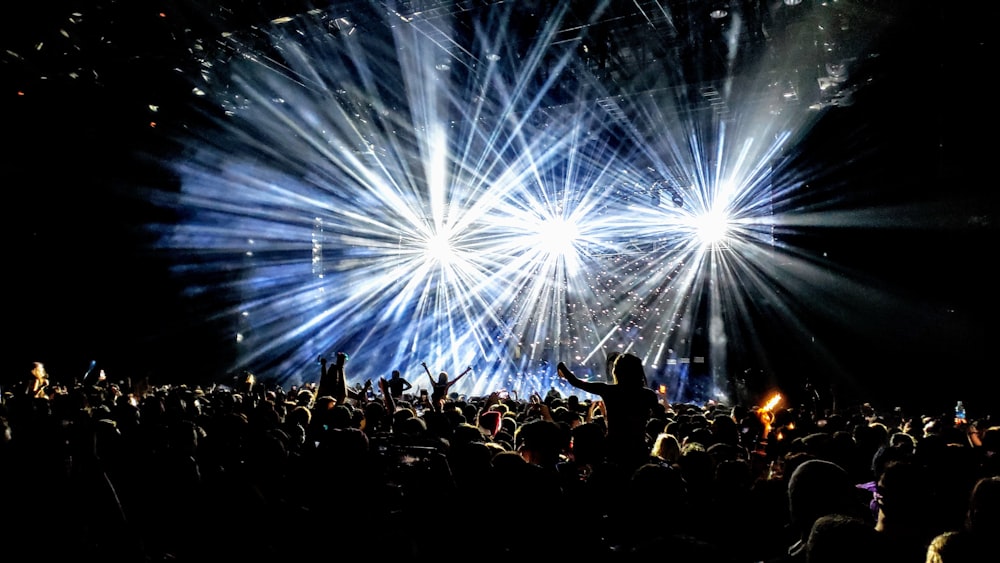 time lapse photography of group of people facing on stage