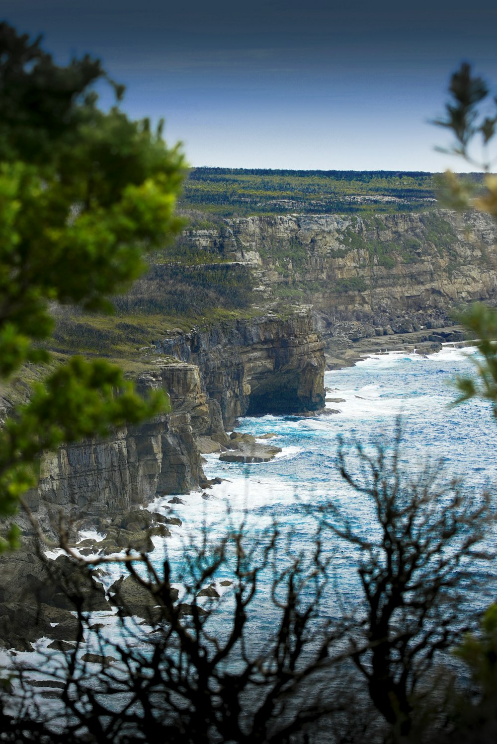 body of water and cliffs during daytime