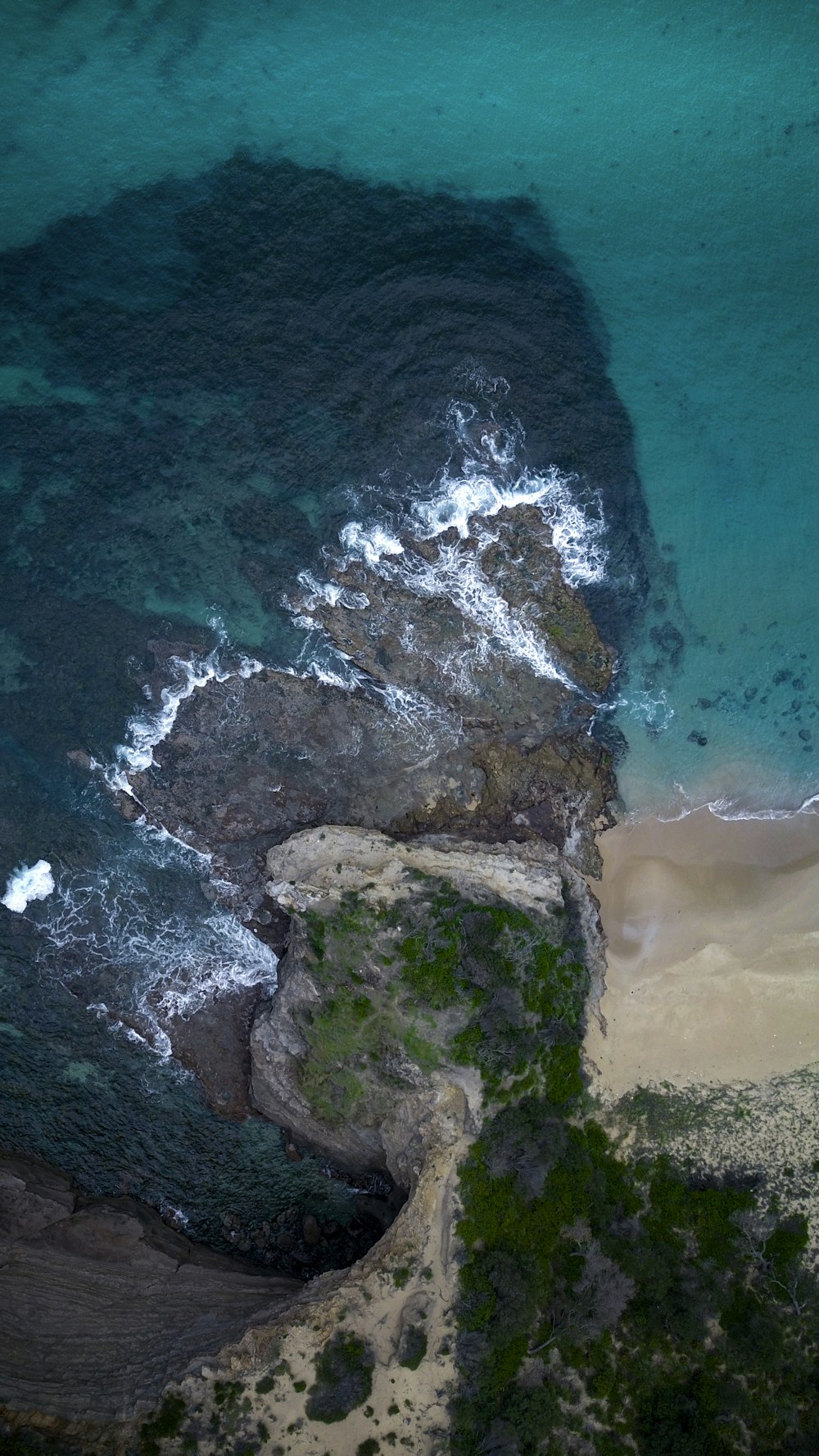 aerial view of rocky hill and ocean