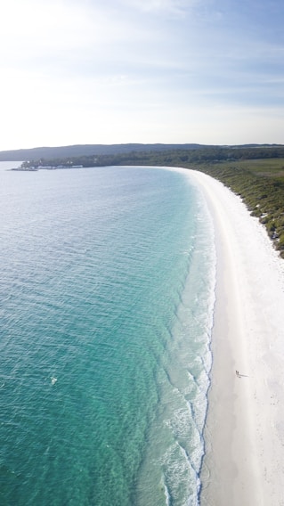A serene beach with turquoise waters and soft white sand.