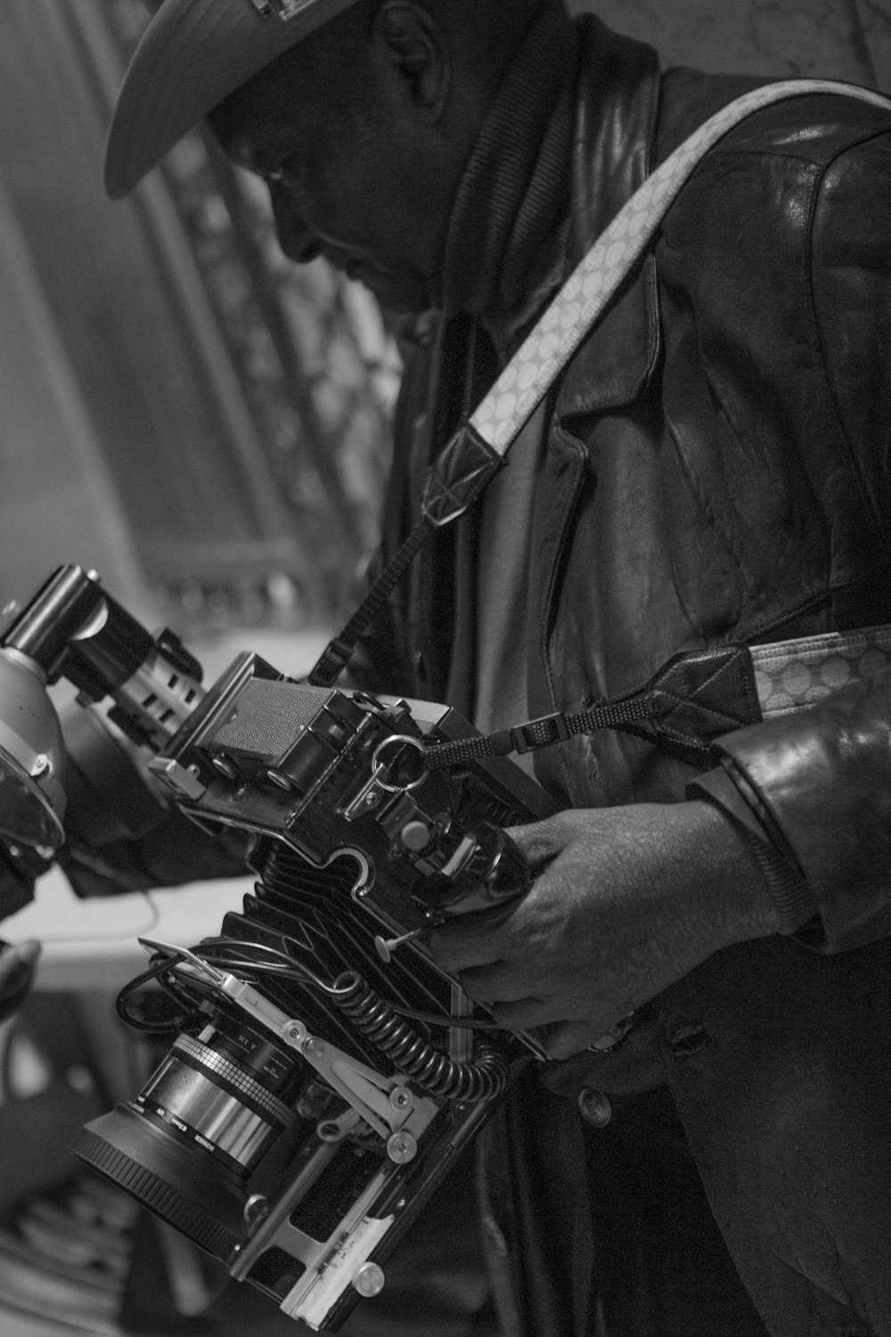 grayscale photography of man holding land camera