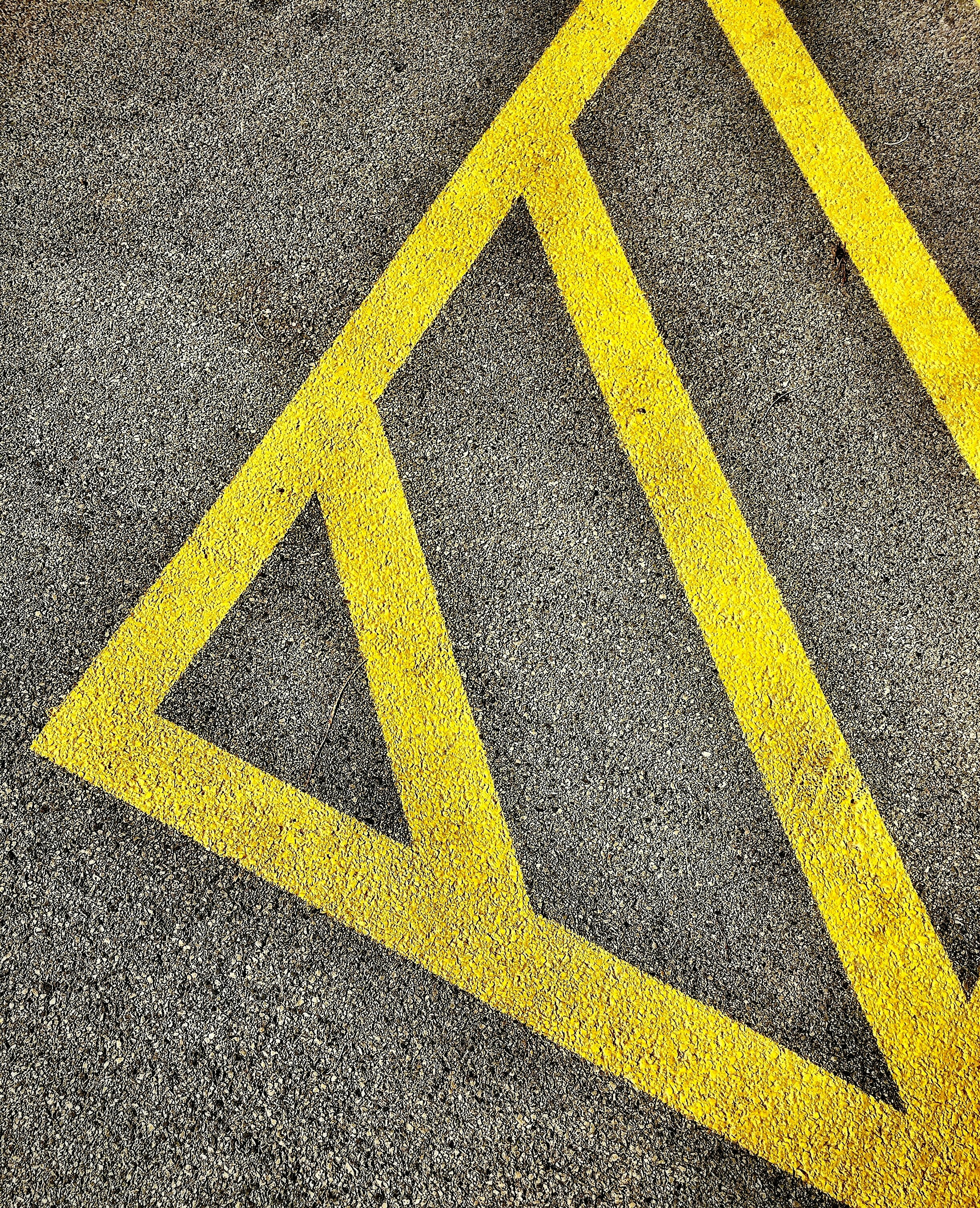 gray and yellow concrete pavement close-up photo