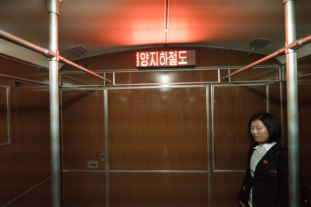 woman standing near the brown wooden wall